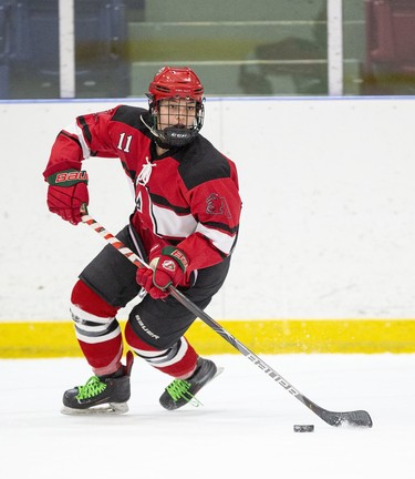 STA Flame Nicole Gosling skates the puck out her end during their TVRA District AA girls hockey game against the St. Joe's Rams at the St. Thomas Elgin Memorial Centre in St. Thomas, Ont. on Tuesday March 3, 2020.The Flames won the game 4-1 forcing a third and final game in their championship series on Wednesday. Derek Ruttan/The London Free Press/Postmedia Network