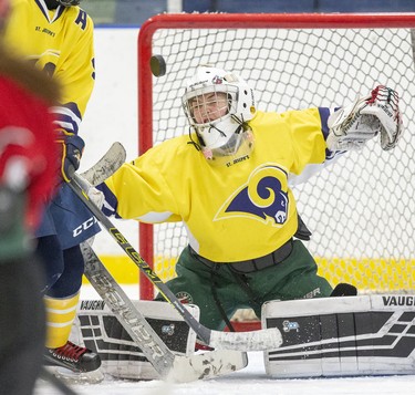 St. Joe's Rams goalie Alyssa Geisbrecht  makes a save during their TVRA District AA girls hockey game against the STA Flames at the St. Thomas Elgin Memorial Centre in St. Thomas, Ont. on Tuesday March 3, 2020.The Flames won the game 4-1 forcing a third and final game in their championship series on Wednesday. Derek Ruttan/The London Free Press/Postmedia Network