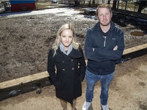 Dr. Karen Geukers and Grade 7-8 teacher Aaron McIntyre pose in front of a mud pit that once housed playground equipment at Lord Elgin elementary school in London. Guekers is helping to raise money to replace the equipment, which was removed as unsafe. (Derek Ruttan/The London Free Press)