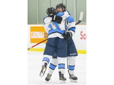 Lucas Vikings players Gabby Kohut (11) and Cierra Troyer celebrate after Kohut opened the scoring in their TRVA Central girls hockey championship game at Stronach Arena in London on Thursday. (Derek Ruttan/The London Free Press)