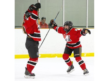 Katherine Heard, left, and Sarah Kennedy celebrate after Heard scores against the Lucas Vikings with two minutes left in the game to give her Medway Cowboys a 3-2 lead. The Cowboys protected their lead for the their eighth consecutive TVRA Central AAA girls hockey championship at Stronach Arena  in London on Thursday. (Derek Ruttan/The London Free Press)