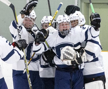 Patterson McNair is swarmed by CCH Crusaders teammates after he scored an empty net goal with ten seconds left to cement a 4-2  win over the Lucas Vikings in the WOSSA AAA championship game at Stronach Arena  in London, Ont. on Tuesday March 10, 2020.  (Derek Ruttan/The London Free Press)