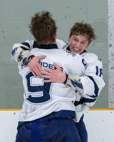 Jonny Diver (16) embraces Alex Laszlo after their CCH Crusaders won the  WOSSA AAA championship game against the Lucas Vikings 4-2 at Stronach Arena  in London, Ont. on Tuesday March 10, 2020.  (Derek Ruttan/The London Free Press)