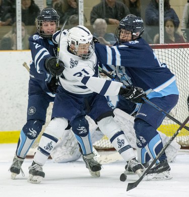 Patterson McNair of the CCH Crusaders tangle with Lucas Vikings players Josh Robbins (left) and Jake Logan during    their WOSSA AAA championship game against the Lucas Vikings at Stronach Arena  in London, Ont. on Tuesday March 10, 2020. The Crusaders went on to win the game 4-2.  (Derek Ruttan/The London Free Press)