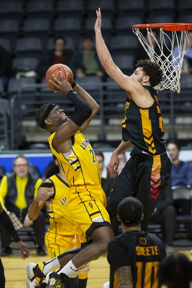 The London Lightning's Abednego Lufile shoots while covered by Brady Skeens of the Sudbury Five during their NBL game at Budweiser Gardens in London on Wednesday. (Derek Ruttan/The London Free Press)