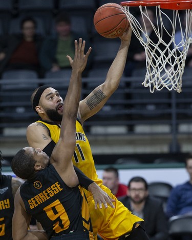 The London Lightning's Cameron Forte lays up two points while covered by George Serresse of the Sudbury Five during their NBL game at Budweiser Gardens in London on Wednesday. (Derek Ruttan/The London Free Press)