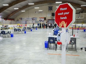 Health workers meet at the back of Oakridge Arena, now serving as a coronavirus assessment centre, in London Tuesday, March 17. (Derek Ruttan/The London Free Press)