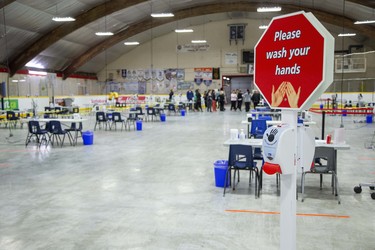 Health workers meet at the back of Oakridge Arena, now serving as a coronavirus assessment centre, in London Tuesday, March 17. (Derek Ruttan/The London Free Press)