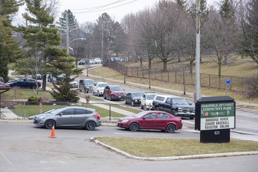 Stretching along Valetta Street a line of vehicles containing people waiting to be seen by health care professionals at the  coronavirus assessment centre  now open at Oakridge Arena in London, Ont. on Tuesday March 17, 2020.  Derek Ruttan/The London Free Press/Postmedia Network