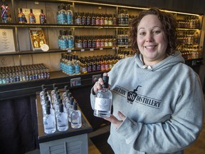 Junction 56 Distillery's Jen Button holds a bottle of antiseptic hand sanitizer that the Stratford, Ontario company began making this week to combat COVID-19. Photo shot on Saturday March 21, 2020. Derek Ruttan/The London Free Press/Postmedia Network