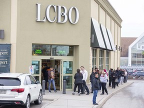 Long lines are sprouting up at liquor stores all over the city with the announcement that all non essential businesses in Ontario must shut down this week. (Derek Ruttan/The London Free Press)