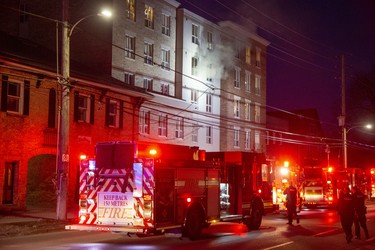 Smoke billows from a 4th floor apartment at 446 King Street in London, Ont. on Friday March 27, 2020. One person was taken to the hospital with unknown injuries from the fire that began around 8:00pm.  Derek Ruttan/The London Free Press/Postmedia Network