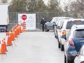 Nine cars were lined up at the 11 a.m. opening of the Oakridge Arena COVID-19 assessment centre in London, Ont. on Sunday March 29, 2020. Derek Ruttan/The London Free Press/Postmedia Network