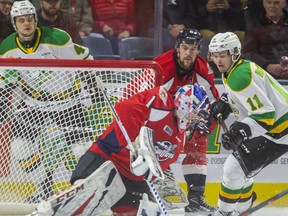 Knight's Connor McMichael looks for the puck from the side of the net as Spits goaltender while being checked by Connor Corcoran of the Spitfires  with teammate Jonathan Gruden as Spits goalie Kari Piiroinen can't control the rebound during the first period of their OHL game.  (Mike Hensen/The London Free Press file photo)