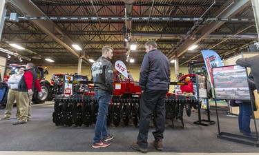 Levi Fretz of Niagara, Ont., talks with Case salesperson Good Mills on the first day of the London Farm Show at the Western Fair Agriplex on Wednesday March 4, 2020. Fretz comes to the London show every year, because it's the biggest indoor farm show in the region and early enough that no one is working their fields.
Mike Hensen/The London Free Press