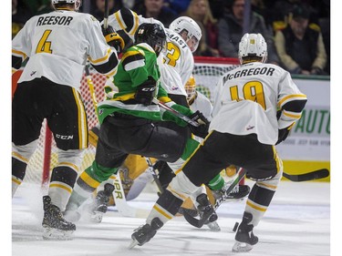 Knights captain Liam Foudy drew a crowd of Sarnia Sting players in Ashton Reesor, Ryan Mast and Ryan McGregor. Foudy still got his stick on the bouncing puck and managed to get it through the five hole of Sting goalie Benjamin Gaudreau for the only goal of the first period period during their OHL game Friday March 6, 2020, at Budweiser Gardens.  (Mike Hensen/The London Free Press)