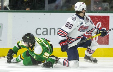 London Knights captain Liam Foudy slides into the end boards and comes up slowly after being taken down by Oshawa's Nico Gross early in their game at Budweiser Gardens in London. 
Photograph taken on Sunday March 8, 2020. Mike Hensen/The London Free Press/Postmedia Network
