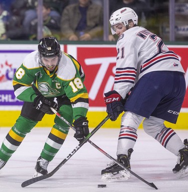 London Knights captain Liam Foudy fights for the puck in the Oshawa end with Jacob Winteron of the Generals early in their game at Budweiser Gardens in London. Photograph taken on Sunday March 8, 2020. Mike Hensen/The London Free Press/Postmedia Network