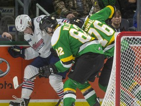 Jason Willms and Billy Moskal of the London Knights fight for the puck behind the Oshawa Generals net against Dawson McKinney of the Generals in a game on March 8 at Budweiser Gardens in London.  Mike Hensen/The London Free Press