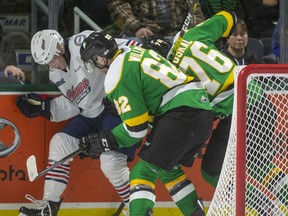 Jason Willms and Billy Moskal of the London Knights fight for the puck behind the Oshawa Generals net against Dawson McKinney of the Generals in their game Sunday at Budweiser Gardens in London. Photograph taken on Sunday March 8, 2020. Mike Hensen/The London Free Press/Postmedia Network