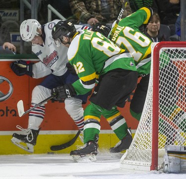 Jason Willms and Billy Moskal of the London Knights fight for the puck behind the Oshawa Generals net against Dawson McKinney of the Generals in their game Sunday at Budweiser Gardens in London. Photograph taken on Sunday March 8, 2020. Mike Hensen/The London Free Press/Postmedia Network