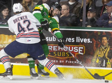 Knights captain Liam Foudy fights to make a pass while being pinned to the boards by Oshawa's Mitchell Brewer in their game at Budweiser Gardens in London. Photograph taken on Sunday March 8, 2020. Mike Hensen/The London Free Press/Postmedia Network