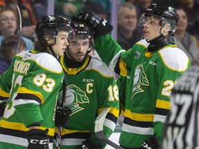 London Knights Kirill Steklov, left, and Hunter Skinner celebrate after team captain Liam Foudy opens the scoring en route to a 3-1 win over the Oshawa Generals at Budweiser Gardens Sunday, March 8. (Mike Hensen/The London Free Press)