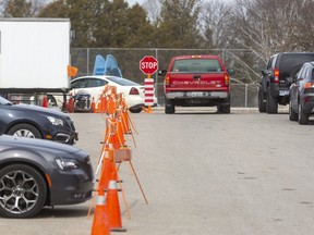 Only three cars wait in the line up at the Covid-19 screening centre set up at Oakridge arena at about 1pm on Wednesday March 18, 2020.  A large change from the long lineups seen yesterday. (Mike Hensen/The London Free Press)