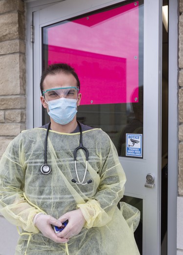 Dr. Mario Elia shows the new face of family medicine at the London Lambeth Family medical clinic located on Colonel Talbot Road just south of Southdale in London, Ont.  Family doctors at the clinic have set up a place to see patients outside by a side door of the clinic, so that the clinic itself and the rooms will remain clean. They are also trying to gather gear for doctors in London especially masks, visors and gowns for the front line workers. Photograph taken on Wednesday March 18, 2020.  (Mike Hensen/The London Free Press)