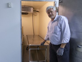 Joe O'Neil, the managing director of O'Neil Funeral Home on William Street in London, Ont. shows their cold storage room Friday, March 20, where they can keep up to four bodies, if needed.O'Neil says they always try to keep a supply on hand. O'Neil is uncertain about the future of funerals amid the outbreak, thinking live-streaming may become much more common, and that the numbers of guests may have to be curtailed. (Mike Hensen/The London Free Press)