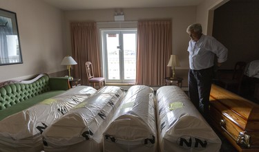 Joe O'Neil the managing director of O'Neil Funeral Home on William Street in London, Ont. shows some of their stock of new coffins that they keep on hand. O'Neil says that they always try to keep a supply on hand, and it isn't a new precaution caused by the Covid-19 pandemic. O'Neil is uncertain about the future of funerals thinking that live streaming may become much more common, or that the numbers of guests may have to be curtailed. Photograph taken on Friday March 20, 2020.  (Mike Hensen/The London Free Press)