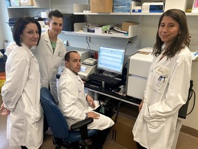 Microbiologist Ana Cabrera, left, clinical lead for implementing London's COVID-19 lab testing, lab technicians Geoff Pereira and Joe Mascarin, and COVID-19 technical lead Shannon Schofield perform coronavirus testing at the Pathology and Laboratory Medicine lab, a joint venture by London Health Sciences Centre and St. Joseph's Health Care London. (Contributed/London Health Sciences Centre)