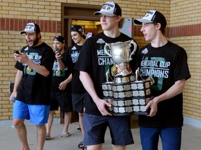 London Knights co-captains Mitch Marner, right, and Christian Dvorak carry the Memorial Cup to show thousands of fans who showed up to greet them in Victoria Park on Monday May 30, 2016. (File photo)