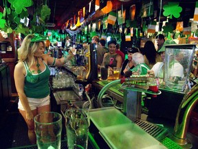 Molly Bloom's bartender Alix Chisholm serves a packed house on St. Patrick's Day in London, Ont. on Thursday March 17, 2016. (Derek Ruttan/The London Free Press)