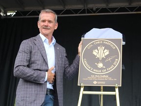 Chris Hadfield is shown Tuesday with his "hometown" star from Canada's Walk of Fame during an event held on the riverfront in Sarnia.