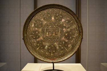 This elaborate tray, made of mother-of-pearl, overlaid in black lacquer on wood was crafted in Gujarat, India between the late 16th and early 17th centuries. Nine angels clad in Persian and Indian costumes encircle a pavilion. This artifact  is one of  more than 1,000 objects available for viewing at the Aga Khan Museum. (BARBARA TAYLOR, The London Free Press)