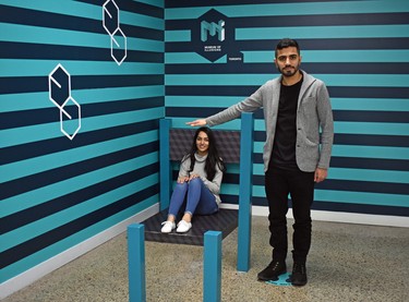 The Museum of Illusions presents dozens of eye-boggling interactive scenarios including this one in which the seated Jasneet "appears" much smaller than Raj. (BARBARA TAYLOR, The London Free Press)