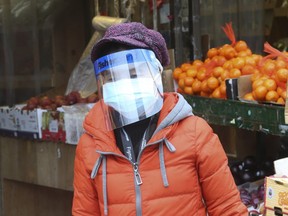 Business as usual at curbside stores and fresh produce markets along Spadina Ave. in Toronto's Chinatown area  on Thursday March 26, 2020. Jack Boland/Toronto Sun/Postmedia Network