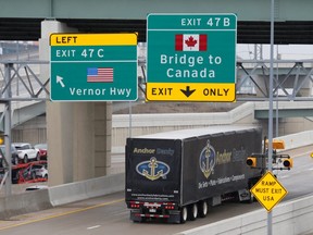 A commercial truck heads for the Ambassador Bridge , during the coronavirus disease (COVID-19) outbreak, at the international border crossing, which connects with Windsor, Ontario, in Detroit, Michigan, U.S., March 18, 2020.      REUTERS/Rebecca Cook ORG XMIT: GGG-DET13