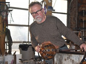 Glassblower Jeremy Popelka creates a vase in his Sturgeon Bay studio. WAYNE NEWTON/SPECIAL TO LONDON FREE PRESS/POSTMEDIA