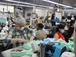 Volunteers do the sewing and Pat Cocco the cutting at Seville Tailors in Burnaby, where they're supplying health-care workers at Surrey Memorial Hospital with protective cloth masks and headwear.