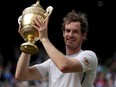 Great Britain's Andy Murray celebrates winning the men's singles Wimbledon final against Canada's Milos Raonic with the trophy in London, England, July 10, 2016.