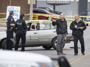 Windsor police are shown investigating at the scene of an assault with a motor vehicle that occurred at the Lube King on Tecumseh Road East between Westcott Road and Aubin Road on Monday, April 6, 2020.
