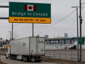 A commercial truck heads for the Ambassador Bridge, during the coronavirus disease (COVID-19) outbreak, at the international border crossing, which connects with Windsor, Ontario, in Detroit, Michigan, U.S., March 18, 2020.      REUTERS/Rebecca Cook ORG XMIT: GGG-DET10