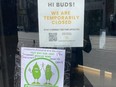 Management at the Hunny Pot cannabis shop on Queen St. W. put up a sign saying they were closed. Someone put a sign advertising black-market weed sales beneath it. (Cameron Brown photo)