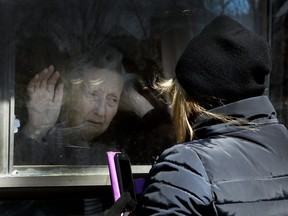 COVID-19-Diane Colangelo visits her 86-year-old mother Patricia through a window at the Orchard Villa long-term care home in Pickering on Wednesday April 22, 2020. Both daughter and mother were in tears. (Veronica Henri/Toronto Sun/Postmedia Network)