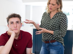 Fed Up Teenage Boy Being Nagged By Mother At Home