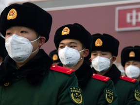 BEIJING, CHINA - JANUARY 26: Chinese police officers wearing masks stand in front of the Tiananmen Gate on January 26, 2020 in Beijing, China. The number of cases of coronavirus rose to 1,975 in mainland China on Sunday. Authorities tightened restrictions on travel and tourism this weekend after putting Wuhan, the capital of Hubei province, under quarantine on Thursday. The spread of the virus corresponds with the first days of the Spring Festival, which is one of the biggest domestic travel weeks of the year in China. Popular tourism landmarks in Beijing including the Forbidden City, Badaling Great Wall, and The Palace Museum were closed to the public starting Saturday. The Beijing Municipal Education Commission announced it will delay reopening schools from kindergarten to university. The death toll on Sunday rose to 56. The majority of fatalities are in Wuhan where the first cases of the virus were reported last month (Photo by Betsy Joles/Getty Images)