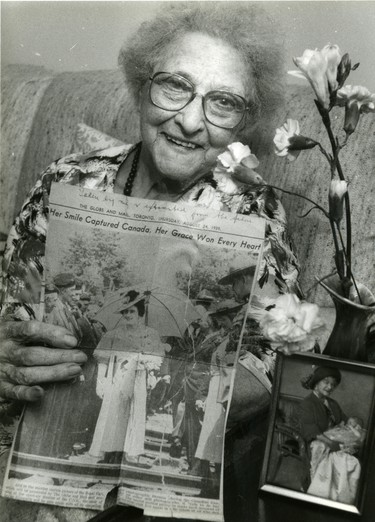 Retired floriest Isabel Baxter of Ingersoll will present the queen mother with a bouquet during her visit, she made the bouquet for a visit 50 years before and holds a newspaper clipping of the event, 1989. (London Free Press files)
