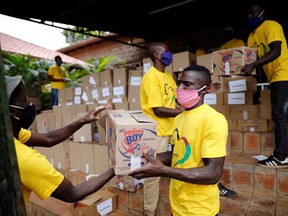 Workers of the Team Pankaj aid group load a truck with boxes with food donations to be distributed for people in need in the capital's poorest neighbourhoods, in Nairobi, Kenya, April 14, 2020. (REUTERS/Baz Ratner)